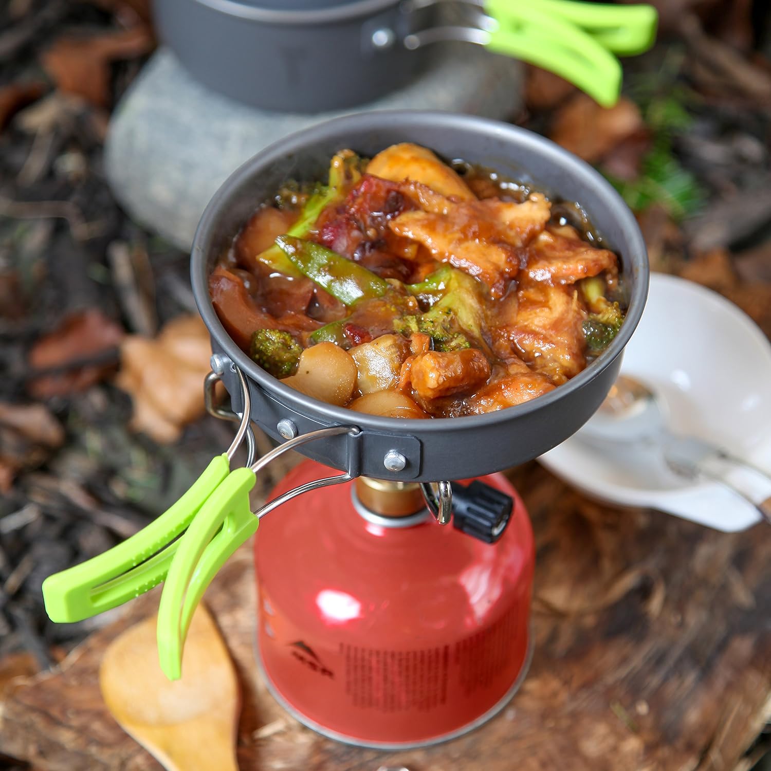 Lightweight camping cookware set for outdoor cooking, includes pot, pan, bowls; anodized aluminum, non-stick, portable.