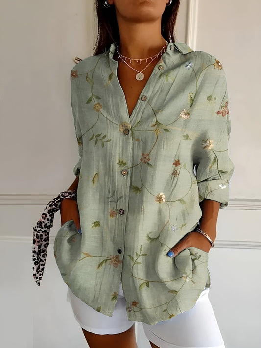 "Lightweight women's button-down summer blouse with classic collar, full-length sleeves, in breathable fabric for sunny days.