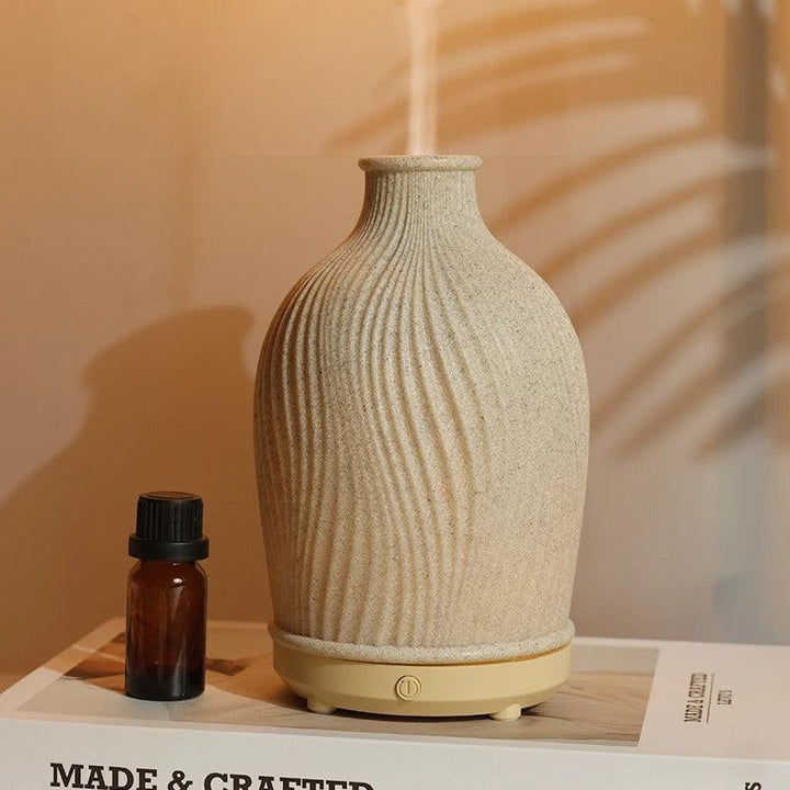 Elegant LED aromatherapy diffuser & humidifier, creating a relaxing ambiance & improving home air.