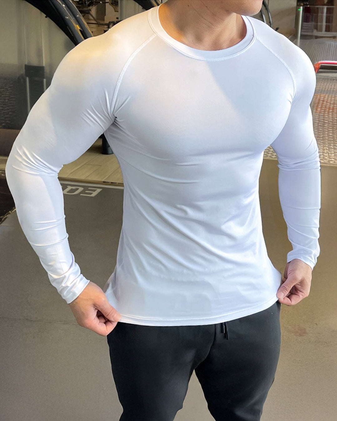 Breathable men's athletic long sleeve shirt, black, with unique shoulder cut detailing