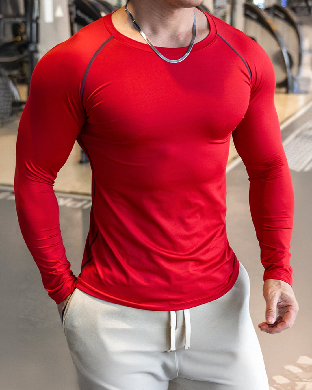 Front view of black men's athletic long sleeve shirt, shoulder cut, perfect for gymwear