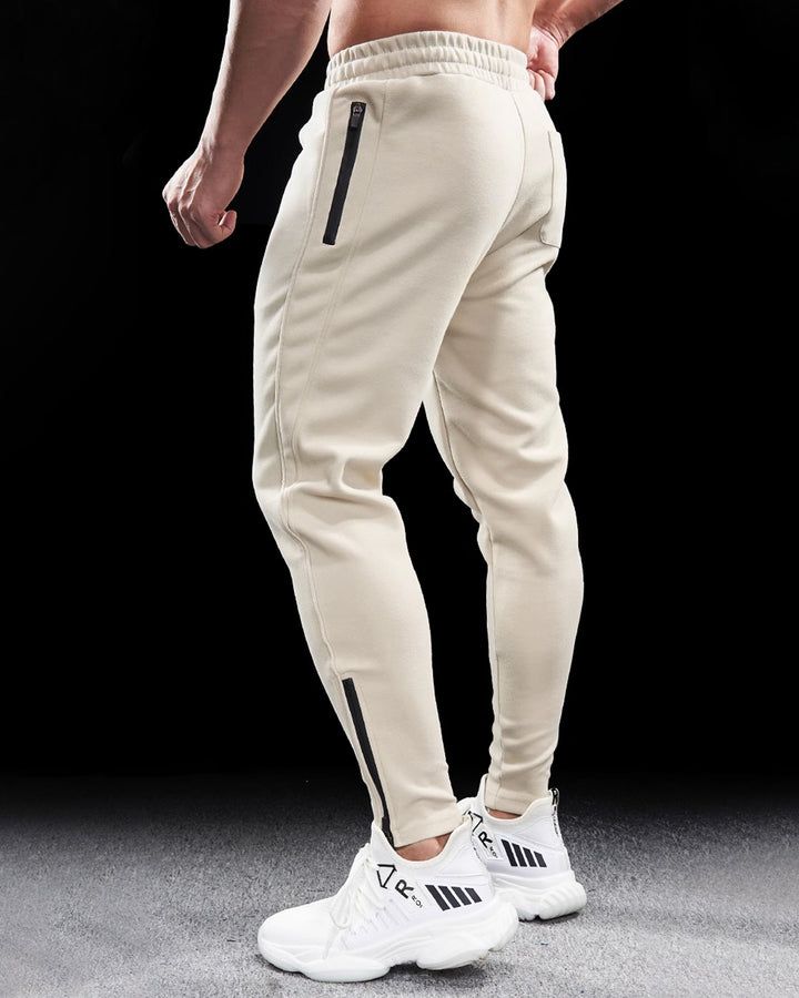 Comfortable men's cotton blend joggers, ideal for exercise or lounging, with stylish tapered fit and zippers.