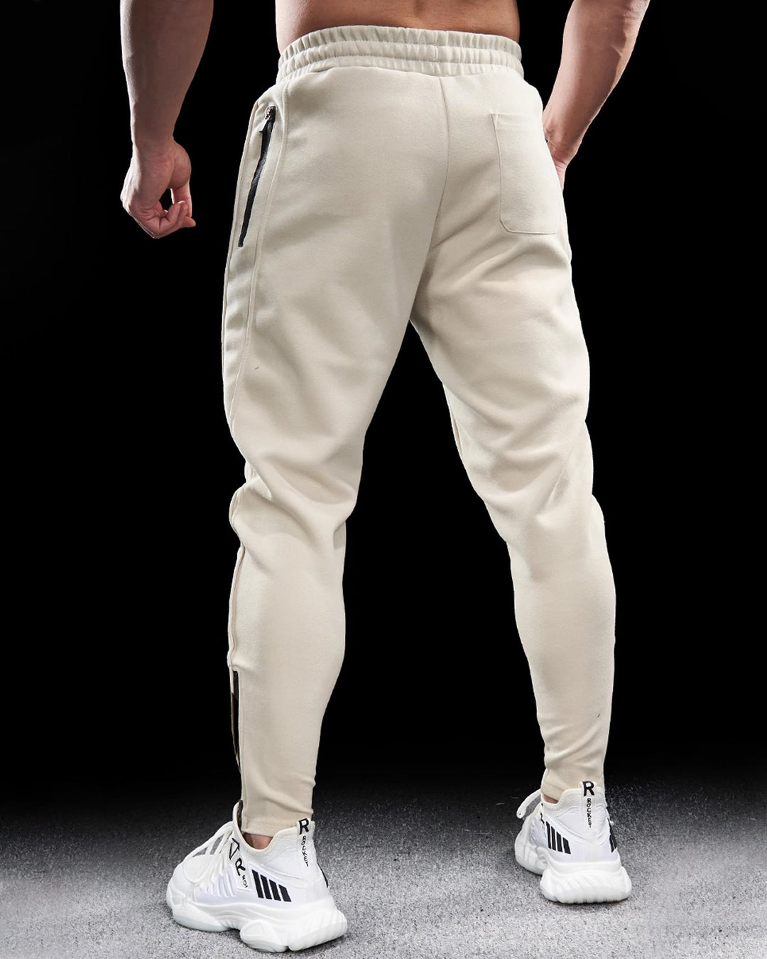 Men's athletic pants, tapered and fitted, with convenient zippered hems for easy on/off and style.