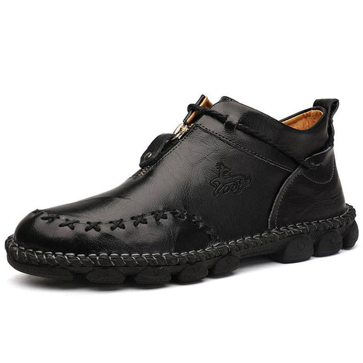 Close-up of men's hand-stitched leather ankle boots, showcasing quality and casual fall fashion.