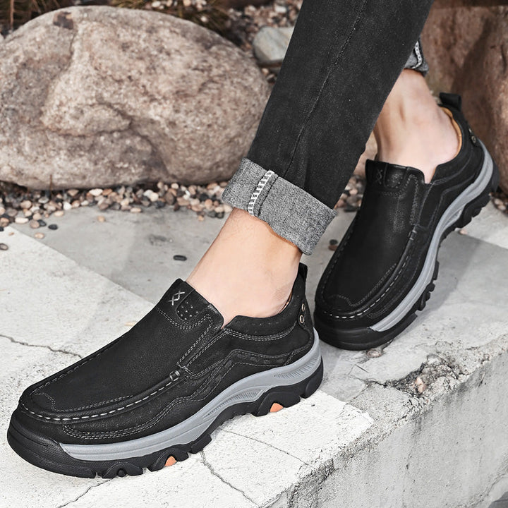 Men's black leather orthopedic slip-ons, ideal for casual wear, walking, and exceptional comfort.