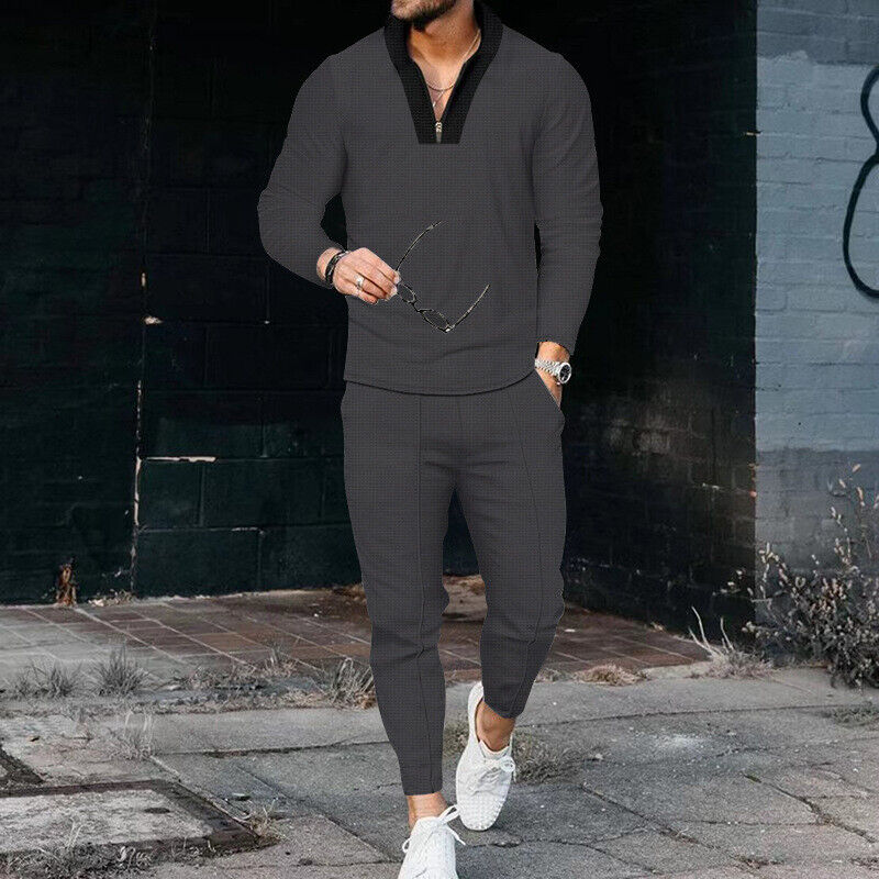 Men's fashion two-piece outfit with a modern zip-up top and trousers for an athletic look.