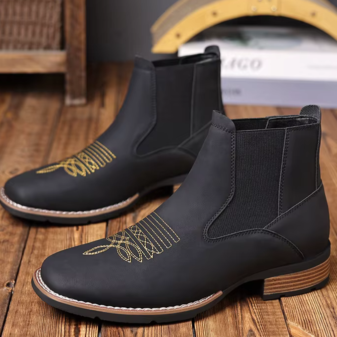 Close-up of the smooth brown leather texture on a men's Western Chelsea ankle boot