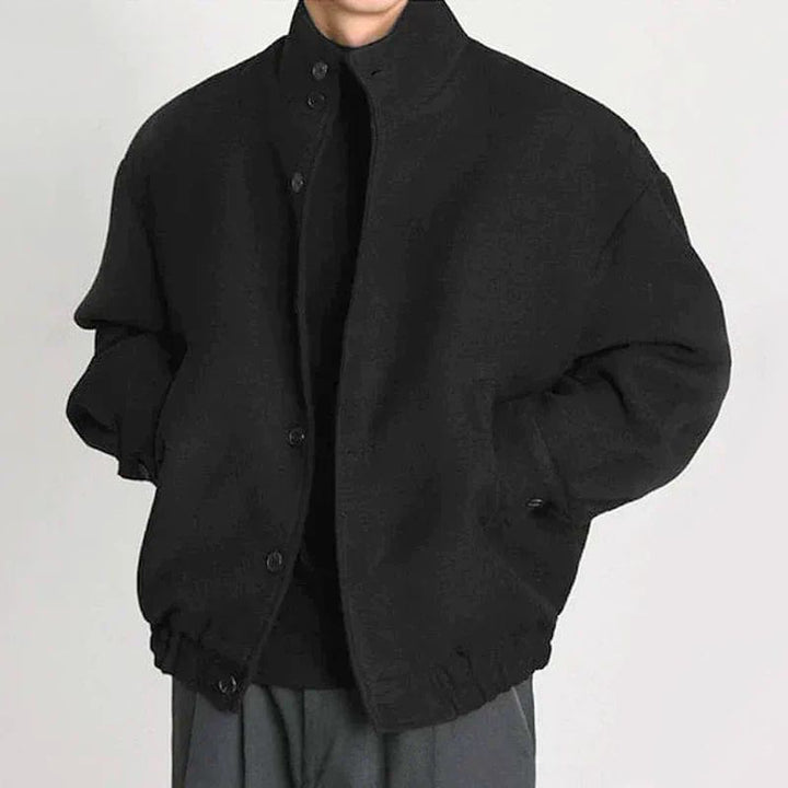 Back view of a men's black wool bomber jacket, highlighting its timeless design and casual style