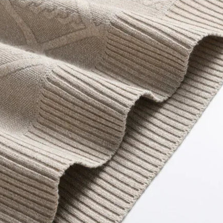 Stylish man in a black cable knit crewneck sweater, demonstrating a modern take on winter fashion.