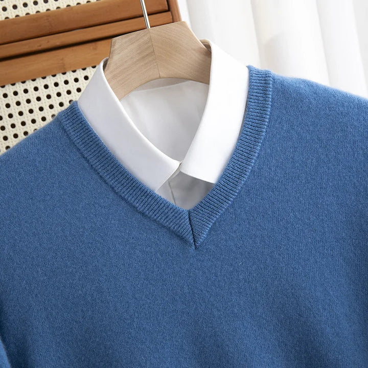 Close-up of a men's red merino wool V-neck sweater, showcasing knit texture and quality fabric