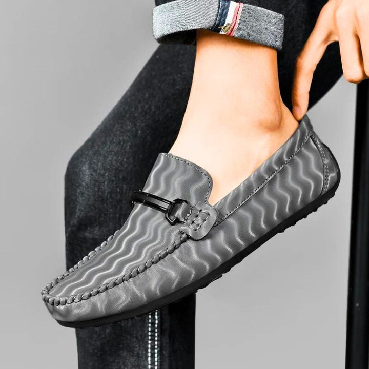 Detailed view of the sole of men's leather loafers, highlighting the durable traction and quality craftsmanship.