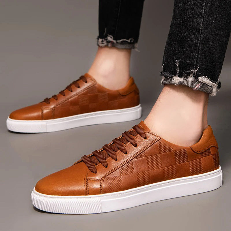 Front view of men's brown leather low-top sneakers, featuring sturdy laces and a classic silhouette