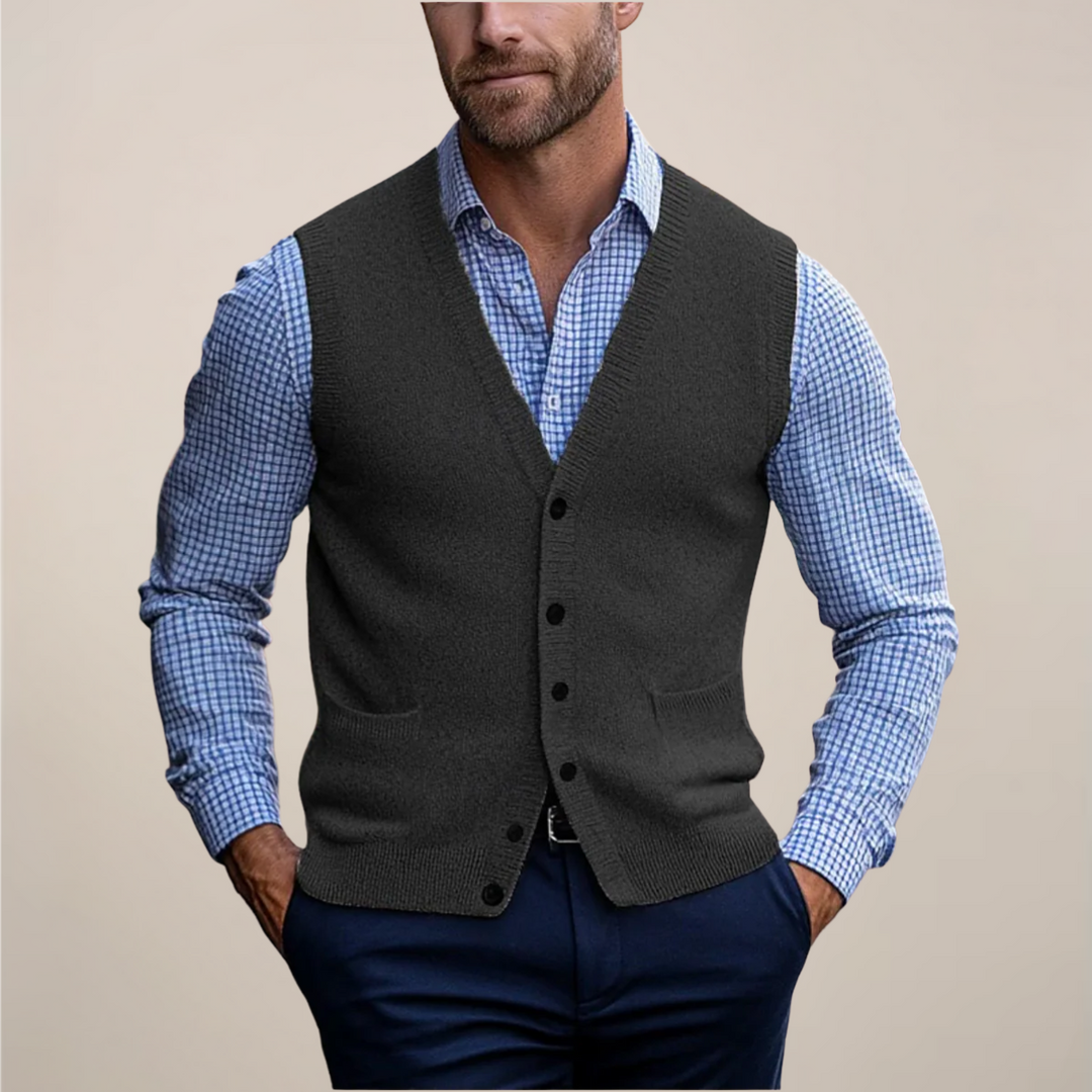 Close-up of a men's knit sweater vest featuring prominent buttons and a ribbed hem.