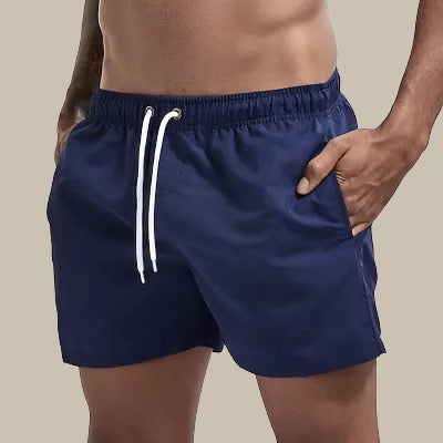 Summer men's swim shorts, quick dry material, and drawstring waist; perfect for beach & pool.