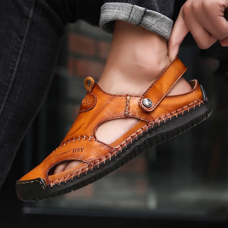 Angled view of men's hand-stitched leather sandals, highlighting the intricate stitching.