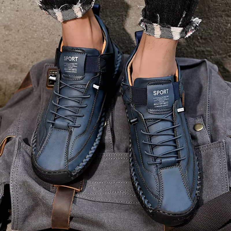 Top down view of black men's orthopedic slip-on leather sneakers, designed for comfort and wide fit.