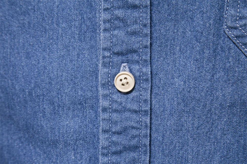 Men's casual light blue denim button-up shirt, a versatile wardrobe staple.