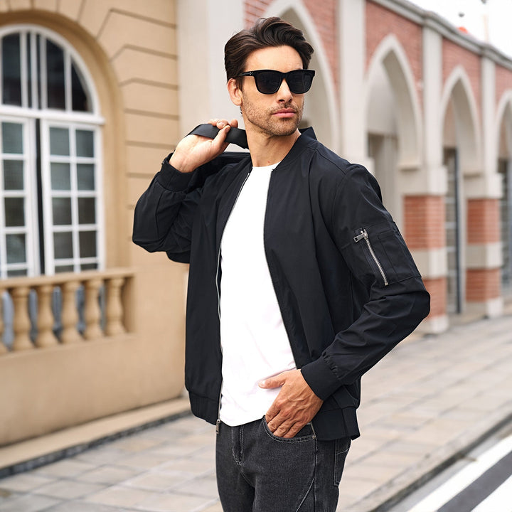 Men's bomber jacket on a hanger, highlighting its clean lines and modern outerwear design