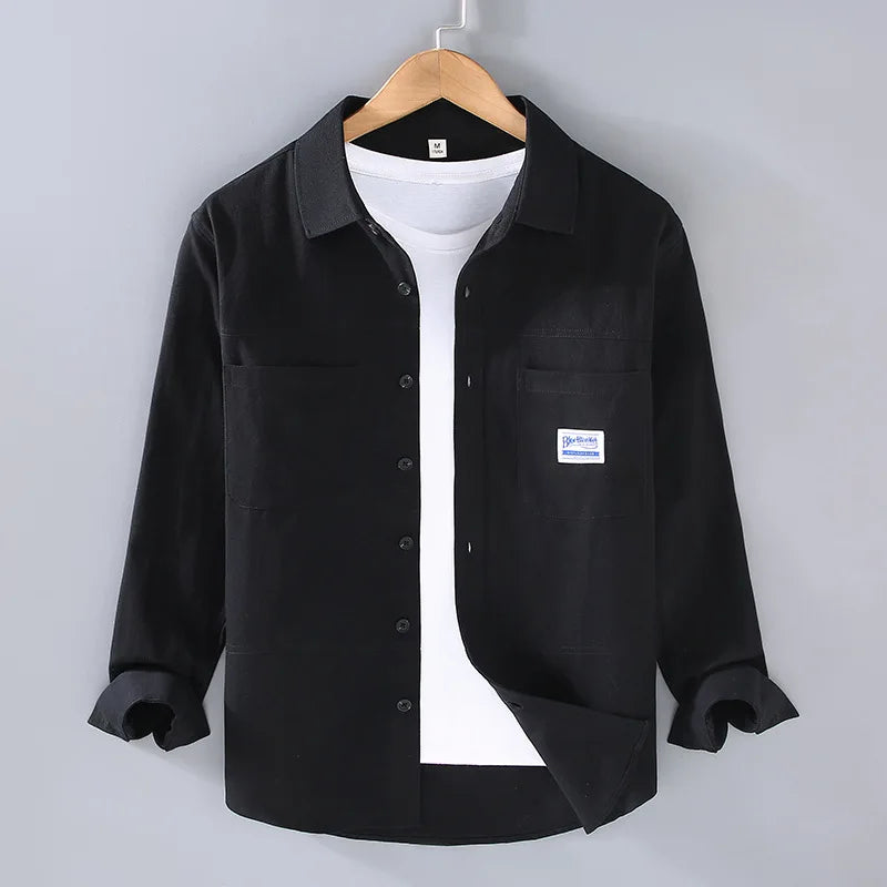 Front view of a classic black long sleeve men's button-down shirt, modern fit