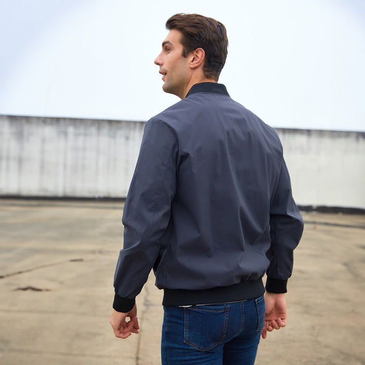 Detailed shot of the waistband on a men's bomber jacket, featuring elastic ribbed trim for comfort