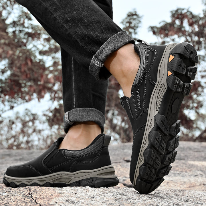 High-angle shot of men's orthopedic slip-on walking shoes in a light studio
