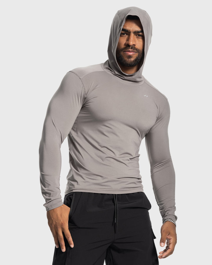 Male model jogging in a white men's baselayer hoodie, demonstrating freedom of movement
