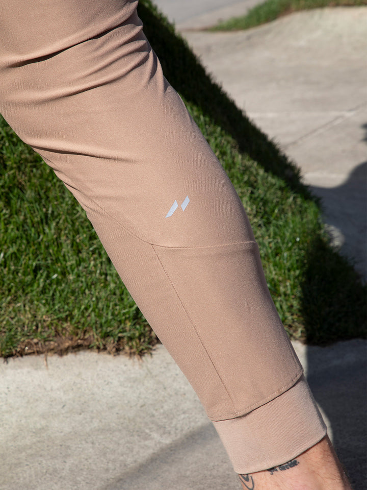 Detail shot of the ankle cuff on men's performance joggers, stretch comfort.