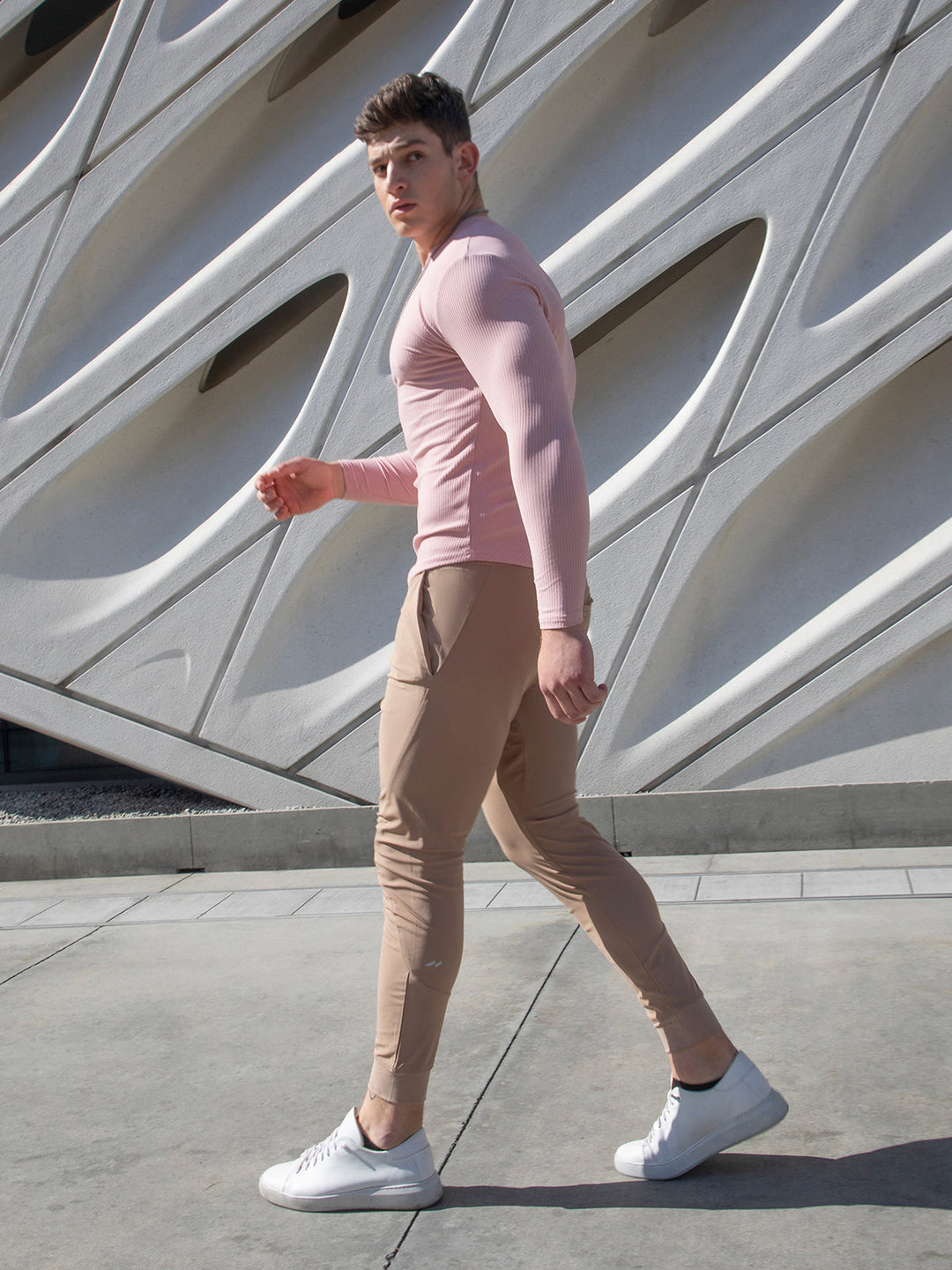 Close-up of the breathable fabric on men's performance joggers, modern fit.