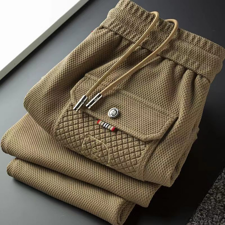Premium loungewear joggers for men, dark grey, highlighting the tapered fit and soft fabric.