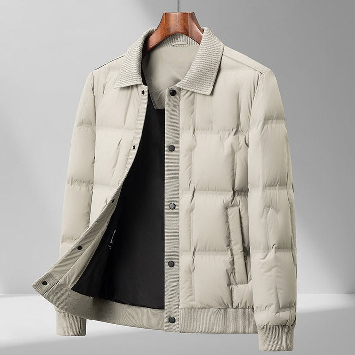 Stylish man wearing an insulated polyester quilted puffer jacket, side view, ideal for cold weather