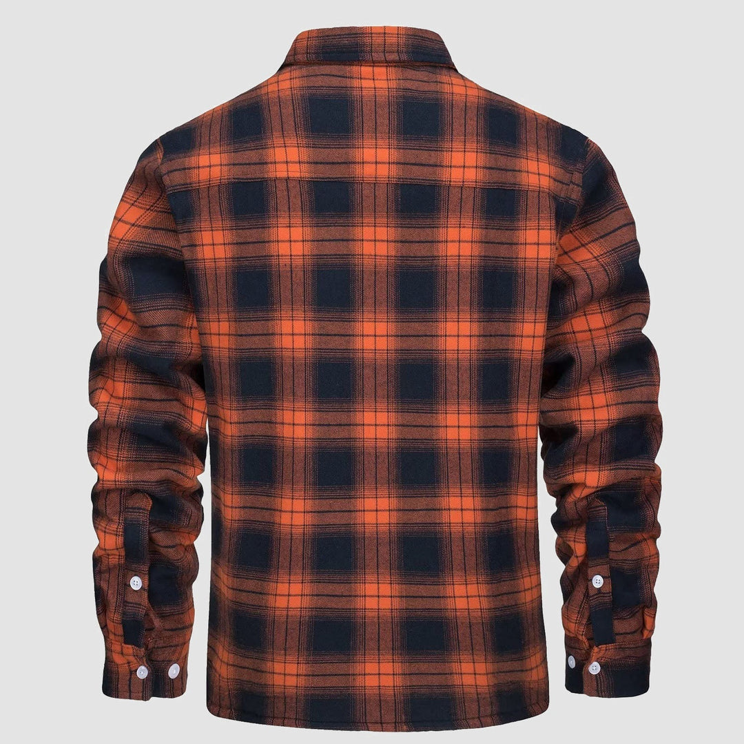 Stack of folded men's flannel button-down fleece lined jackets in various plaid patterns for winter