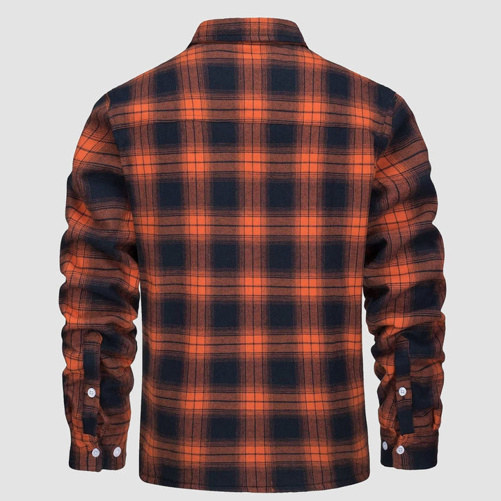 Stack of folded men's flannel button-down fleece lined jackets in various plaid patterns for winter