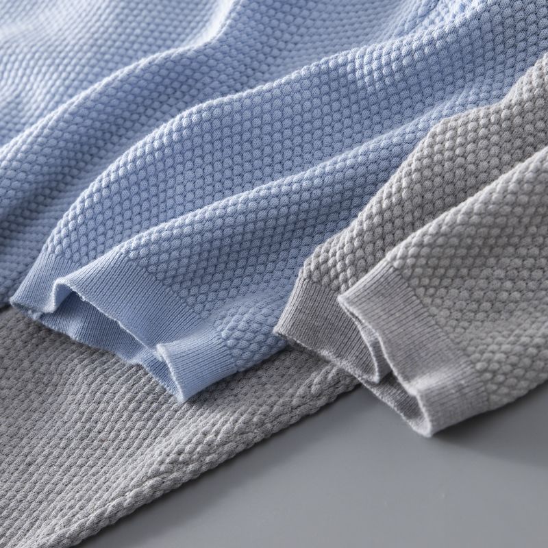 Textured fabric men's polo shirt, knit design, and open collar for modern casual wear.