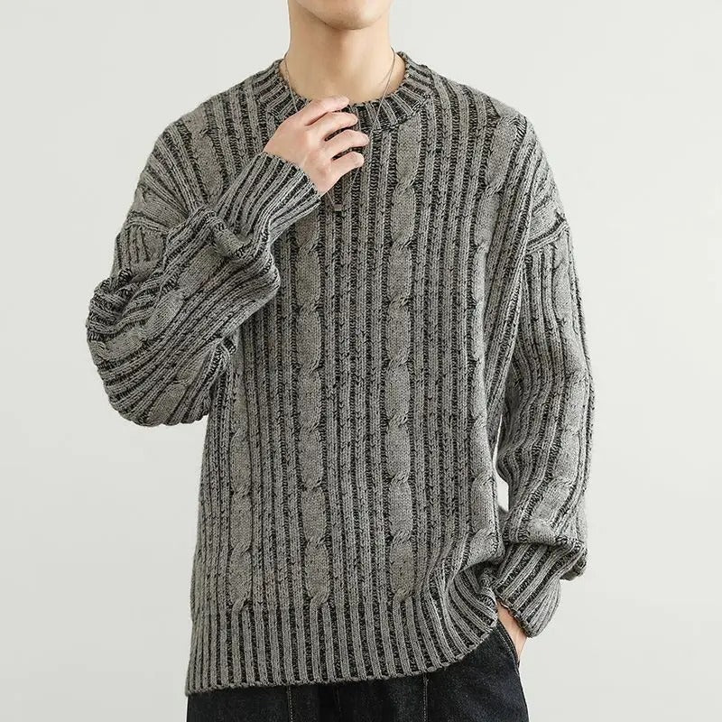 Close-up of a men's navy and white striped cable knit sweater, showcasing texture and detail.