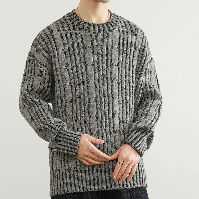 Comfortable men's knitwear: a striped cable knit sweater, ideal for chilly weather and style.