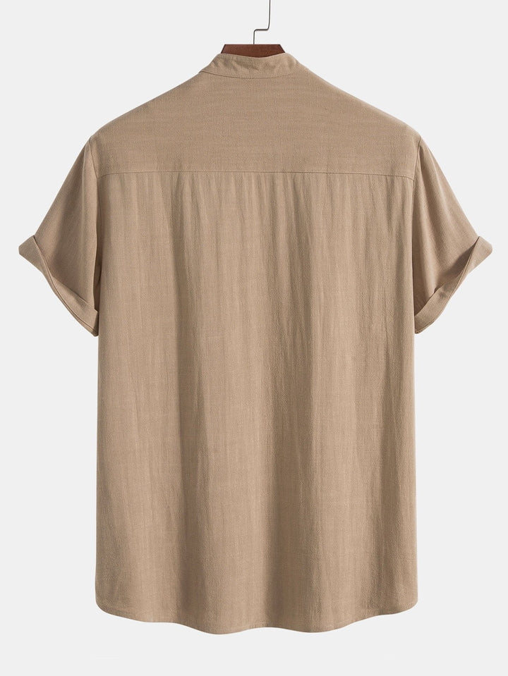Men's modern band collar outfit set: short sleeve shirt and comfortable matching trousers for stylish ease.