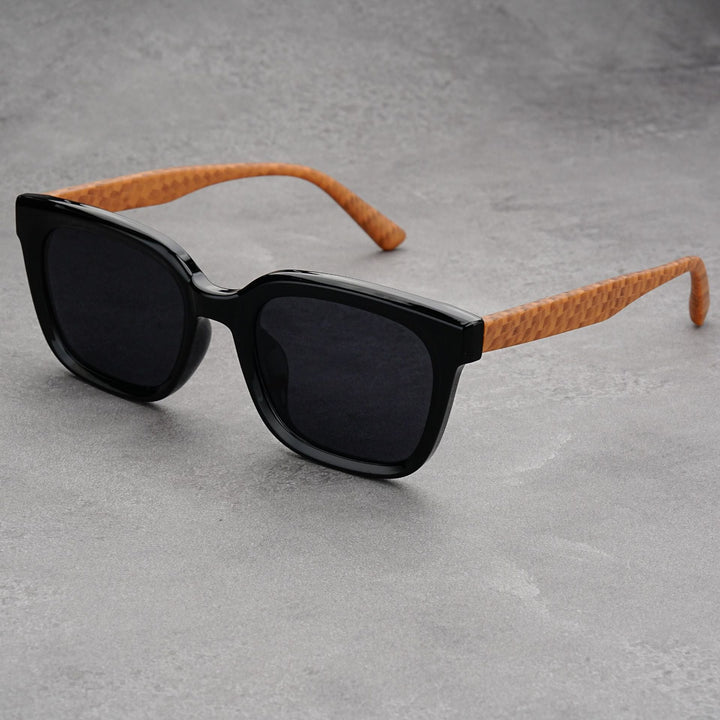 Close-up of men's stylish square frame sunglasses, showcasing their sleek design and UV protection.