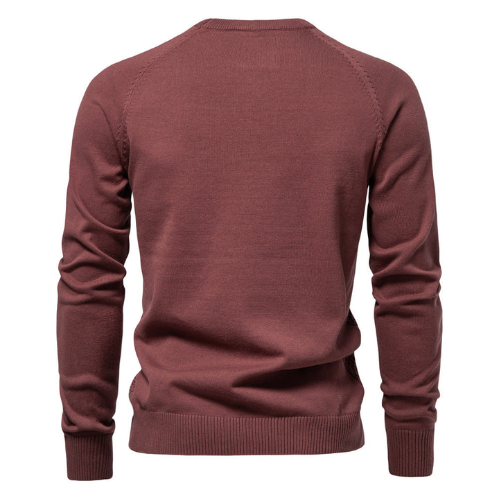 Close-up of the hemline and waffle knit detail of the men's cotton blend crewneck sweater