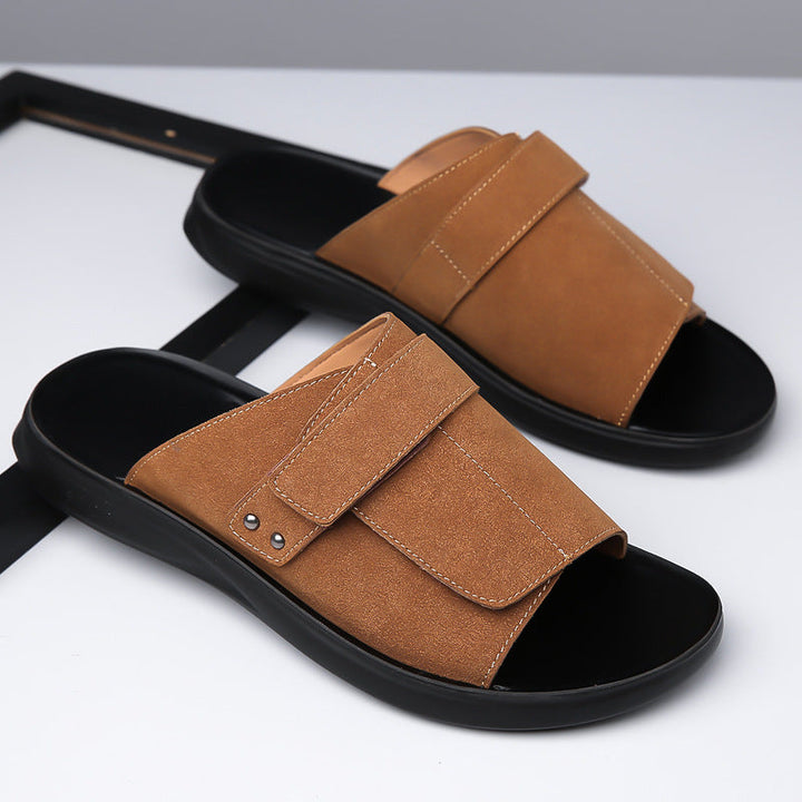 Side view of mens suede slides, featuring a comfortable footbed and adjustable strap.