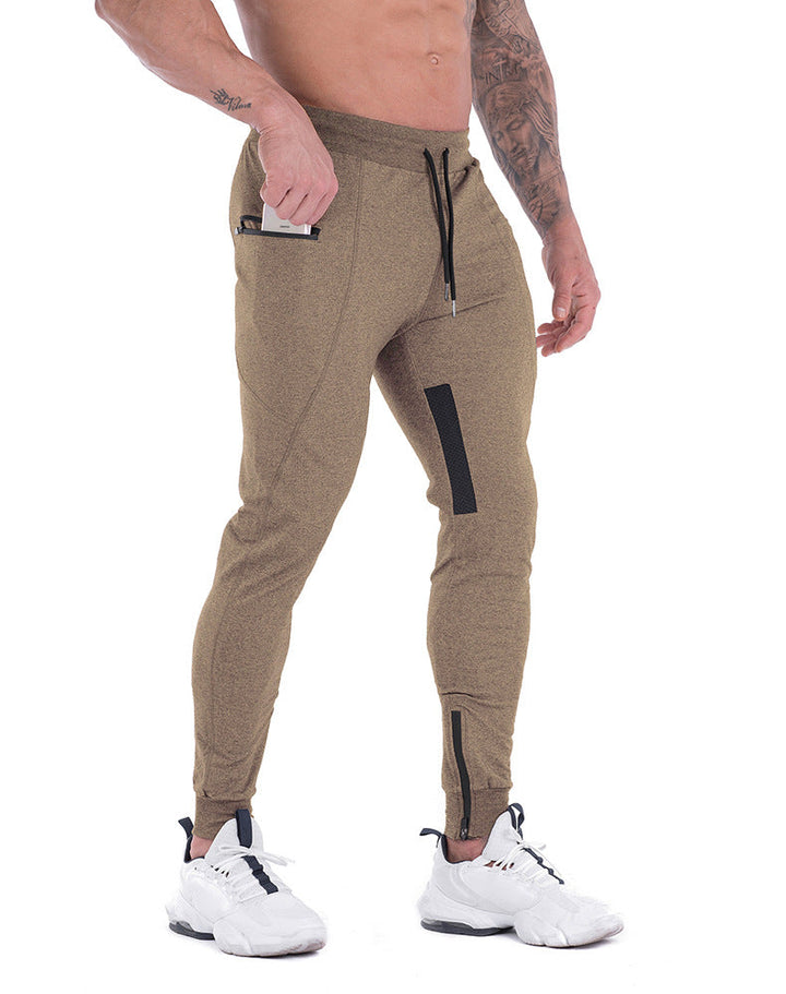 Model wearing olive green men's tapered athletic joggers, suitable for active lifestyles
