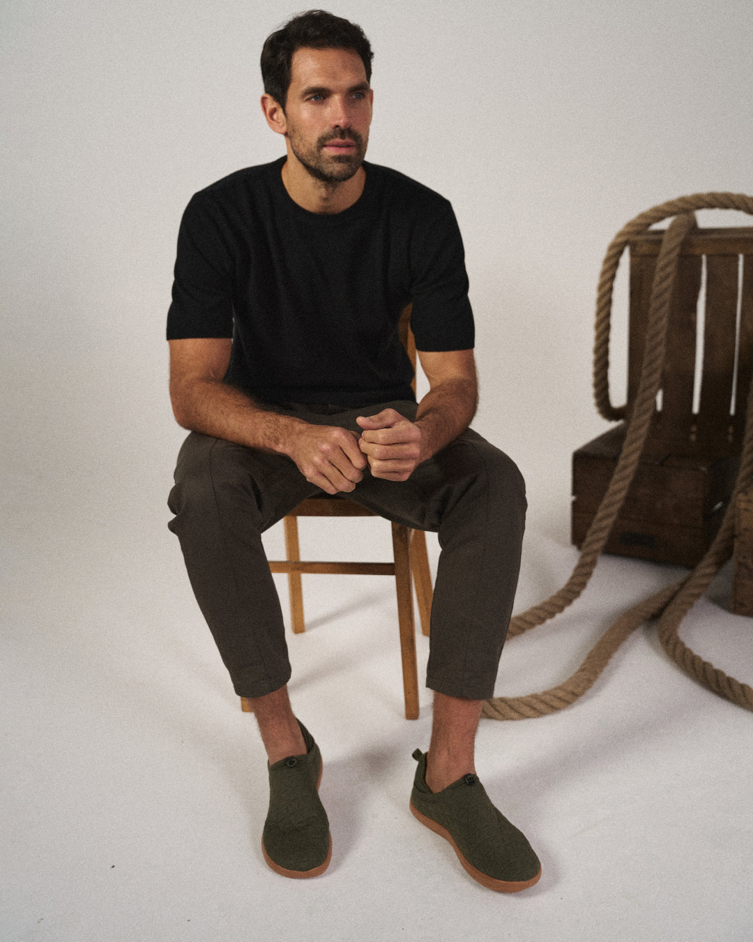 Man wearing black tapered joggers, showcasing the drawstring waist and relaxed fit for lounge.