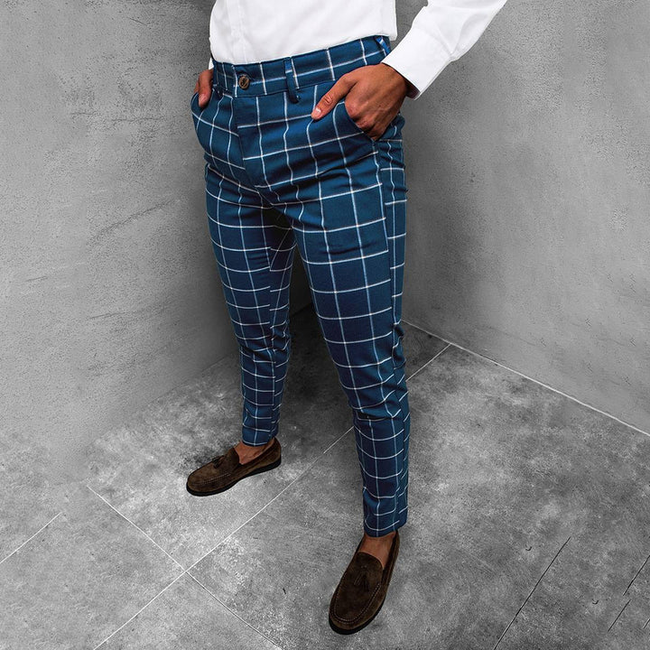 Men's tapered grid pattern trousers, dark blue, side view, modern fit, versatile style.