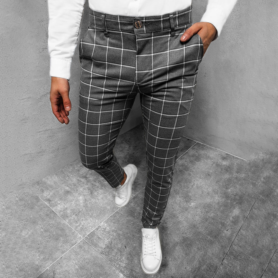 Back view of men's tapered grid pattern trousers, showing pocket detail and sleek cut.