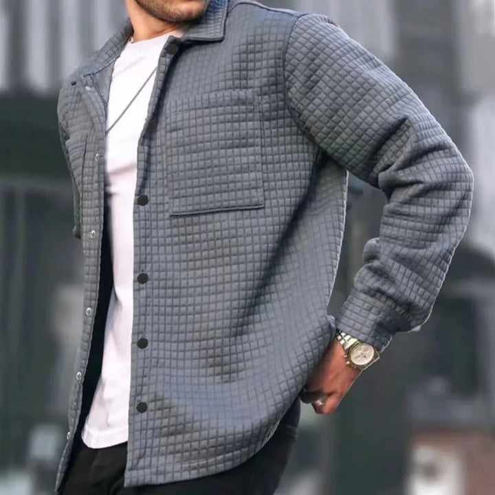 Close-up of a men's textured button-down jacket showing fabric detail, ideal for casual wear.