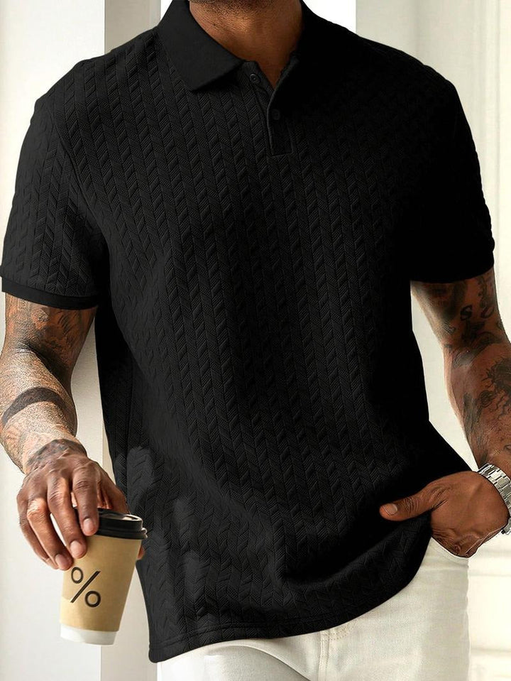 Close-up of men's short sleeve textured knit polo, showcasing the detailed geometric pattern and fabric