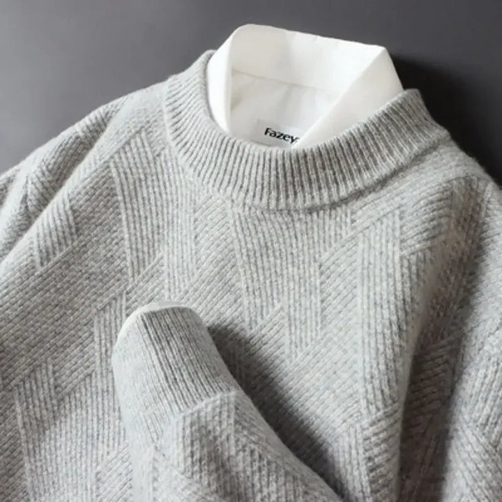 A man models a casual men's textured sweater, illustrating its comfortable fit and classic crew neck design.