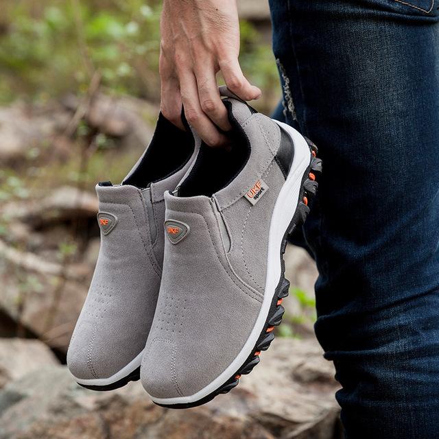Men's athletic waterproof slip-on shoe in a natural outdoor setting, ready for adventure