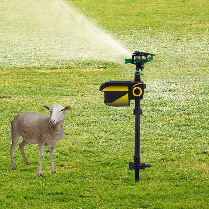 "Motion-activated animal repellent garden sprinkler in action, spraying water; eco-friendly tool for pest control and irrigat
