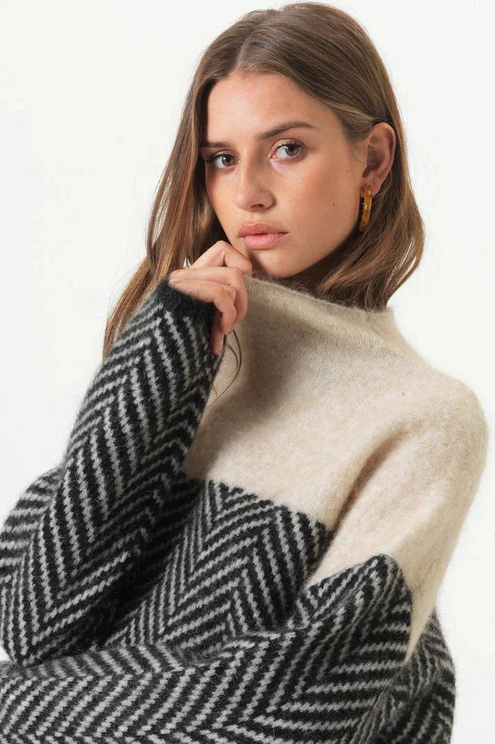 Navy blue herringbone knit sweater with stand-up collar, soft texture, relaxed fit. Women's hoodies and sweaters collection.