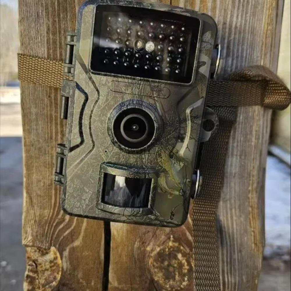 "Outdoor night vision wildlife trail camera capturing nocturnal wildlife with 16MP photos and HD videos in rugged terrain."